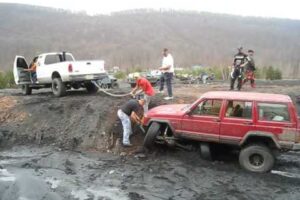 How “NOT” to pull a truck out of the mud!!