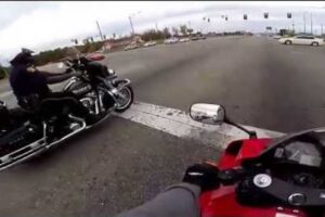 Rider drag races a motorbike cop