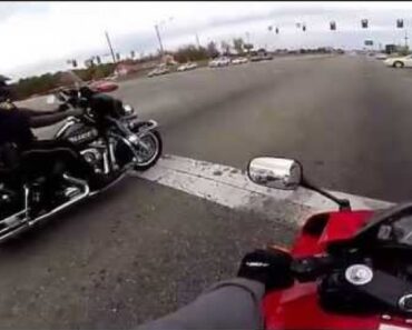 Rider drag races a motorbike cop