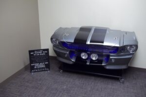 The ultimate cave piece of your gearhead dreams- Eleanor Shelby TV lift display!