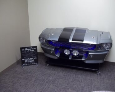 The ultimate cave piece of your gearhead dreams- Eleanor Shelby TV lift display!