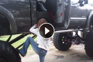 Cute Girl Giving a Struggle to Climb into Giant Ford F-250